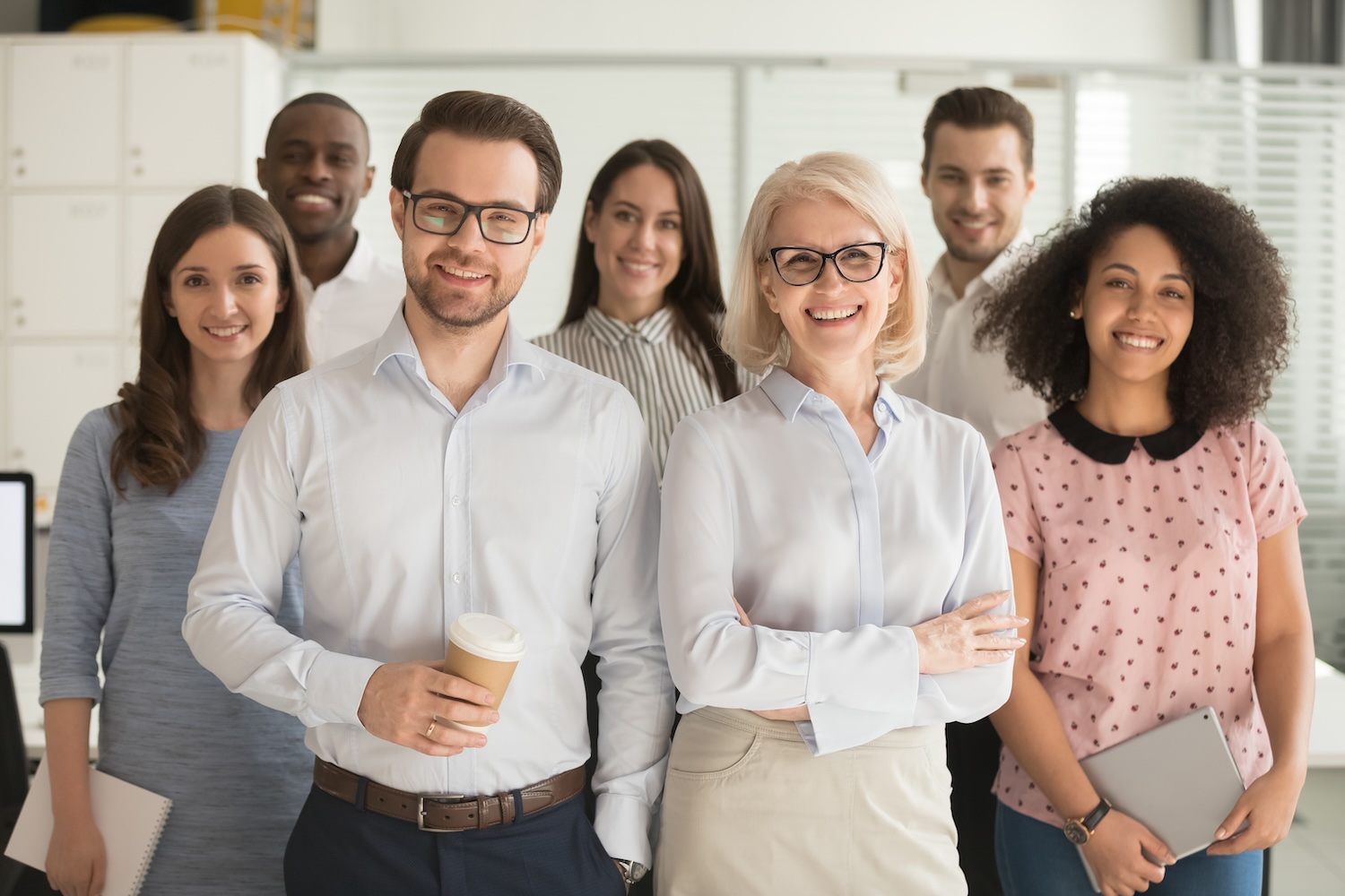 smiling professional business leaders and employees group team portrait